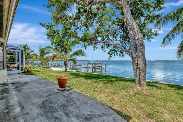 1701 Bayshore Dr, Hutchinson Island, FL 34949 - view of grassy yard with a water view, a dock, and boat lift