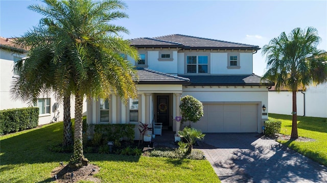 10427 Royal Cypress Way, Orlando, FL 32836 - view of front facade with an attached garage, driveway, stucco siding, and a front lawn
