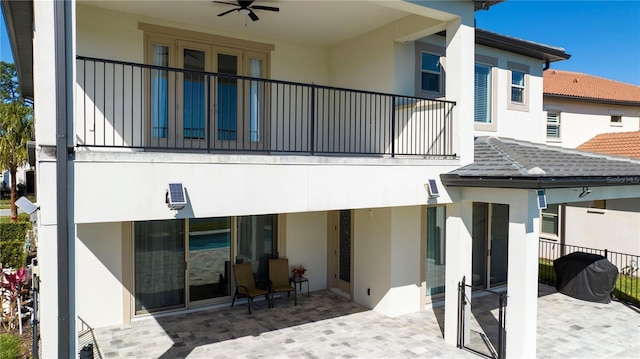 10427 Royal Cypress Way, Orlando, FL 32836 - back of house with stucco siding, a patio, and a balcony