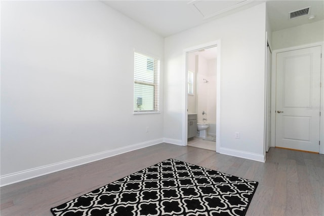10427 Royal Cypress Way, Orlando, FL 32836 - unfurnished bedroom featuring wood finished floors and connected bathroom