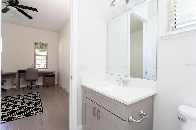 10427 Royal Cypress Way, Orlando, FL 32836 - half bathroom featuring wood finished floors, vanity, and a ceiling fan