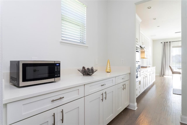 10427 Royal Cypress Way, Orlando, FL 32836 - hallway featuring dark wood-type flooring and baseboards