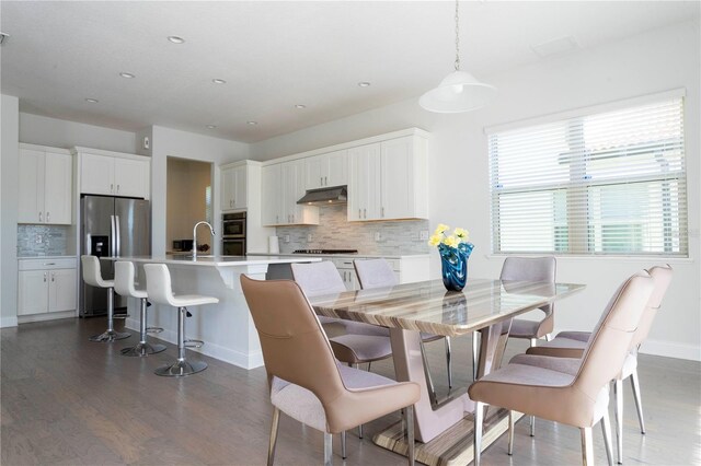 10427 Royal Cypress Way, Orlando, FL 32836 - dining area with wood finished floors and recessed lighting