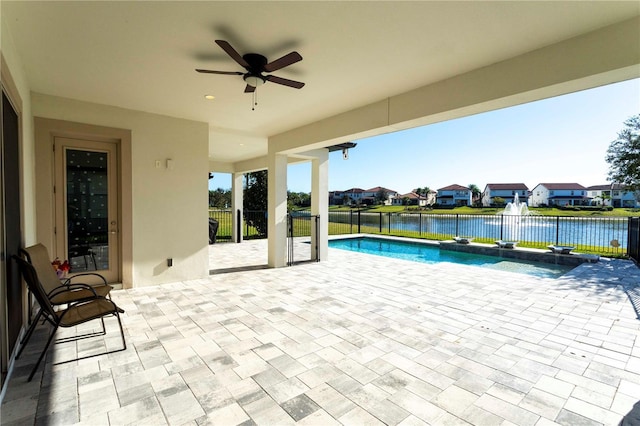 10427 Royal Cypress Way, Orlando, FL 32836 - fenced backyard with a patio, a ceiling fan, a residential view, and a water view
