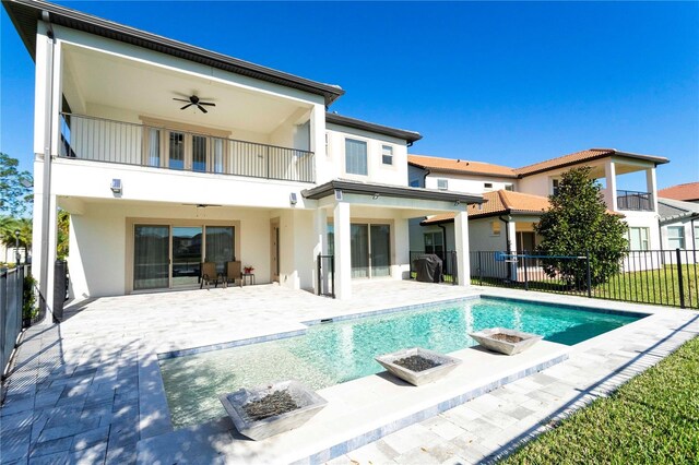 10427 Royal Cypress Way, Orlando, FL 32836 - back of property featuring a balcony, ceiling fan, a fire pit, and a fenced backyard