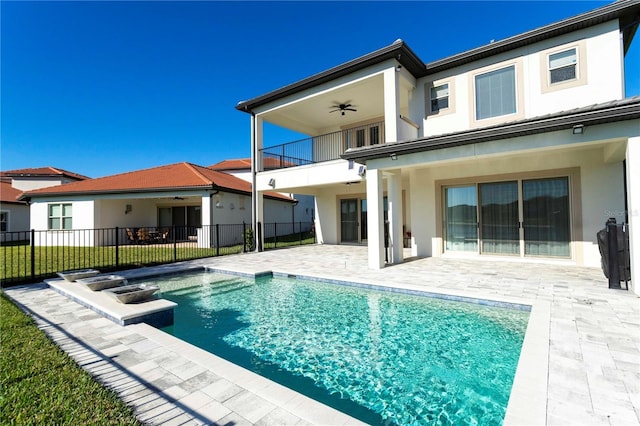 10427 Royal Cypress Way, Orlando, FL 32836 - rear view of house with a ceiling fan, a balcony, a patio, and stucco siding