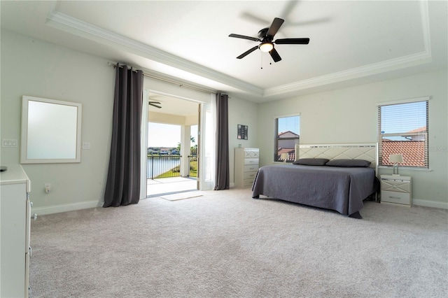 10427 Royal Cypress Way, Orlando, FL 32836 - bedroom with a tray ceiling, ornamental molding, access to exterior, carpet, and a water view