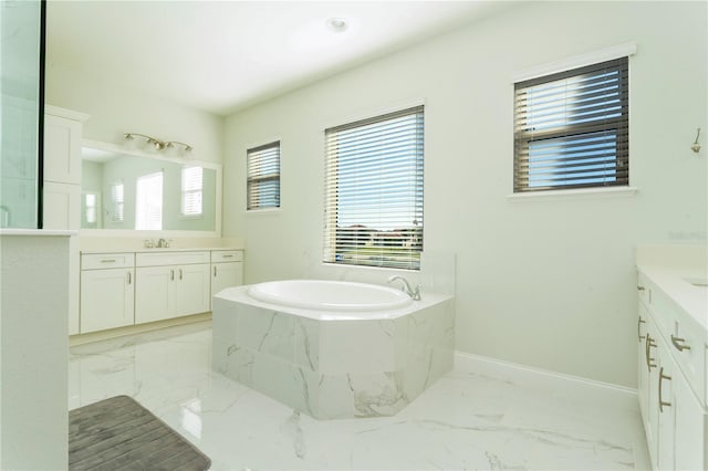 10427 Royal Cypress Way, Orlando, FL 32836 - bathroom featuring two vanities, a bath, and healthy amount of natural light