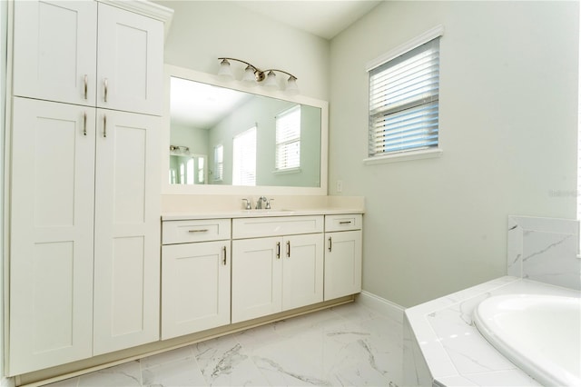 10427 Royal Cypress Way, Orlando, FL 32836 - bathroom featuring vanity, marble finish floors, and a tub