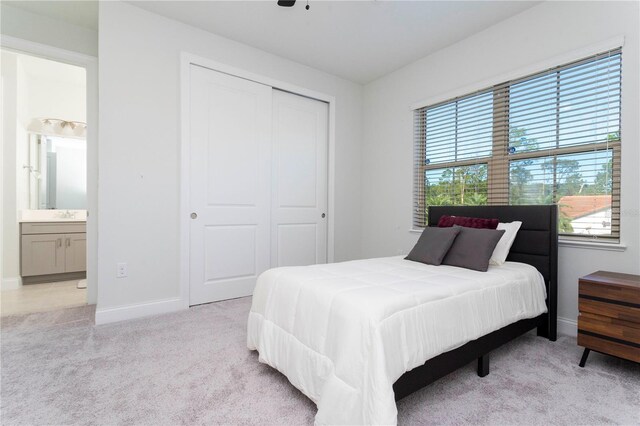 10427 Royal Cypress Way, Orlando, FL 32836 - bedroom featuring light colored carpet, a closet, and ensuite bath
