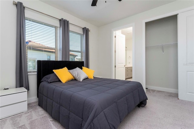 10427 Royal Cypress Way, Orlando, FL 32836 - bedroom with light carpet, ensuite bathroom, a ceiling fan, and a closet