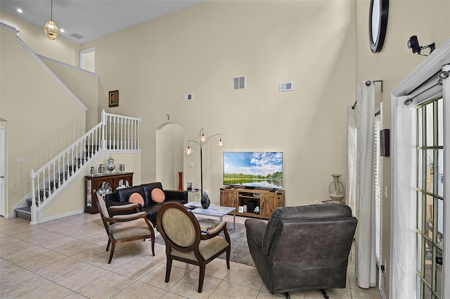 14213 Southern Red Maple Dr, Orlando, FL 32828 - living area with a high ceiling, stairway, and light tile patterned flooring