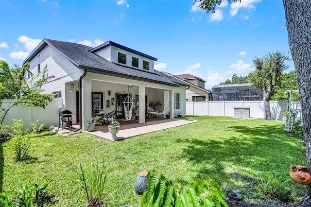14213 Southern Red Maple Dr, Orlando, FL 32828 - rear view of property with stucco siding, a fenced backyard, roof with shingles, and a patio area