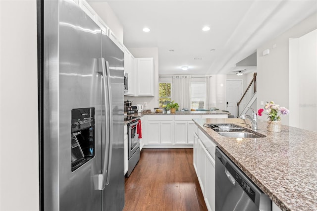 11686 Water Run Aly, Windermere, FL 34786 - kitchen featuring appliances with stainless steel finishes, dark wood-style flooring, light stone counters, white cabinets, and recessed lighting