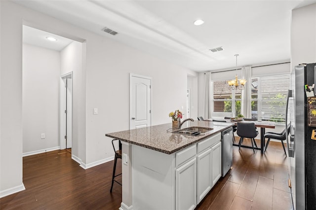 11686 Water Run Aly, Windermere, FL 34786 - kitchen featuring stainless steel appliances, dark wood-style floors, a chandelier, dark stone countertops, and white cabinets