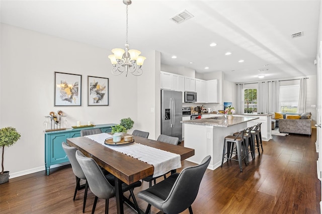 11686 Water Run Aly, Windermere, FL 34786 - dining room with dark wood finished floors, a chandelier, and recessed lighting