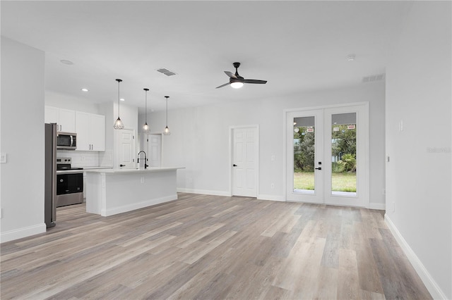 4447 Heyward St, North Port, FL 34291 - unfurnished living room with light wood-style flooring, a ceiling fan, recessed lighting, and french doors