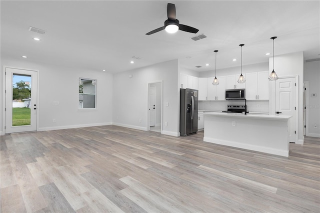 4447 Heyward St, North Port, FL 34291 - unfurnished living room with light wood-style flooring, recessed lighting, and a ceiling fan