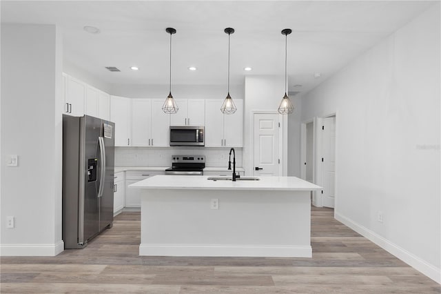 4447 Heyward St, North Port, FL 34291 - kitchen featuring appliances with stainless steel finishes, tasteful backsplash, light countertops, an island with sink, and recessed lighting