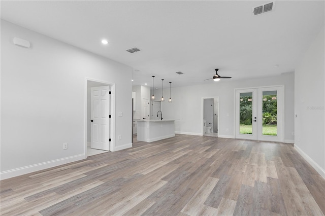 4447 Heyward St, North Port, FL 34291 - unfurnished living room with light wood finished floors, a ceiling fan, recessed lighting, and french doors