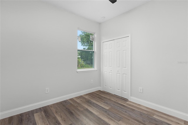 4447 Heyward St, North Port, FL 34291 - unfurnished bedroom with dark wood-style flooring, a closet, and a ceiling fan