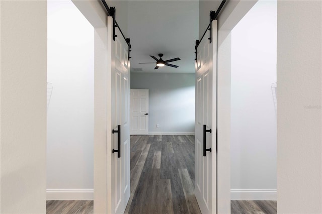 4447 Heyward St, North Port, FL 34291 - hall featuring a barn door and wood finished floors