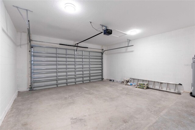 4447 Heyward St, North Port, FL 34291 - garage with a garage door opener, concrete block wall, and water heater
