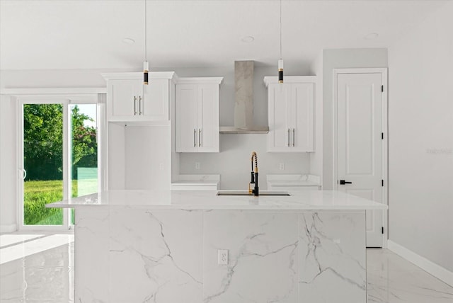 2446 Greenway, Sanford, FL 32771 - kitchen featuring a center island, wall chimney exhaust hood, light marble finish flooring, white cabinets, and light stone counters
