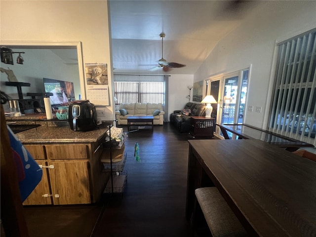 3767 Hibiscus St, Big Pine Key, FL 33043 - kitchen featuring dark wood-style flooring, a ceiling fan, brown cabinetry, dark countertops, and vaulted ceiling
