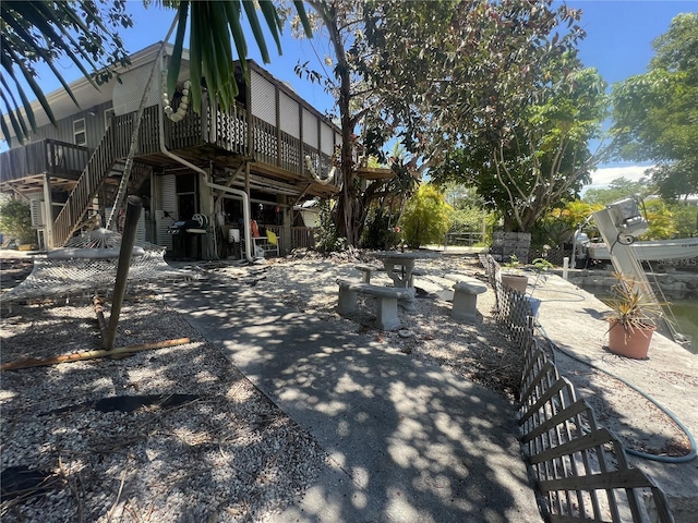 3767 Hibiscus St, Big Pine Key, FL 33043 - rear view of house featuring stairs and a wooden deck