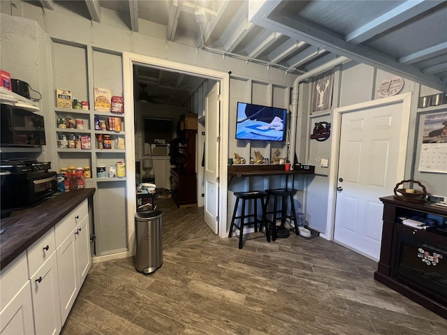 3767 Hibiscus St, Big Pine Key, FL 33043 - interior space featuring butcher block counters, white cabinets, and dark wood-style floors
