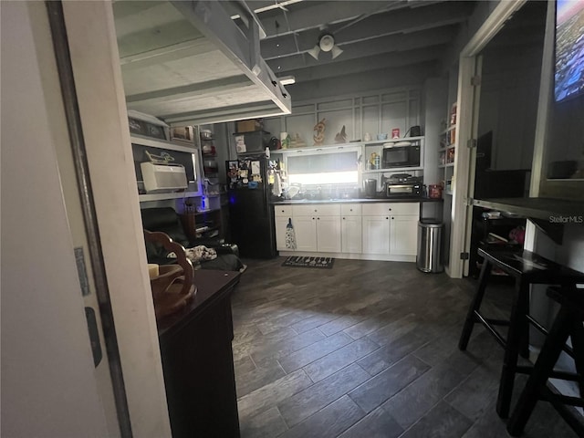 3767 Hibiscus St, Big Pine Key, FL 33043 - kitchen featuring white cabinets, freestanding refrigerator, and dark countertops