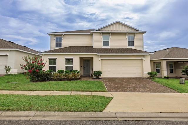 565 Ogelthorpe Dr, Davenport, FL 33897 - traditional-style home with decorative driveway, a shingled roof, a front yard, an attached garage, and stucco siding