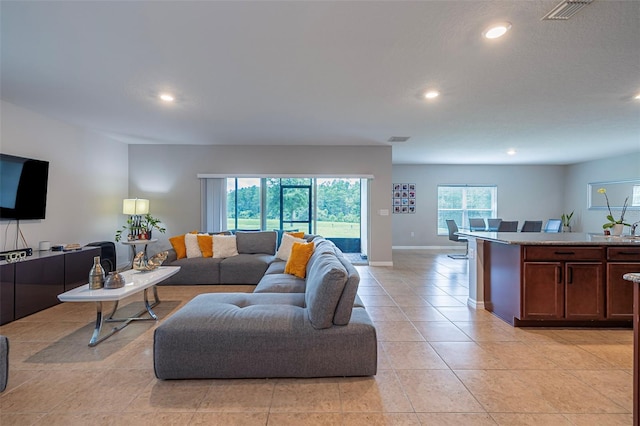 565 Ogelthorpe Dr, Davenport, FL 33897 - living room with recessed lighting and light tile patterned floors