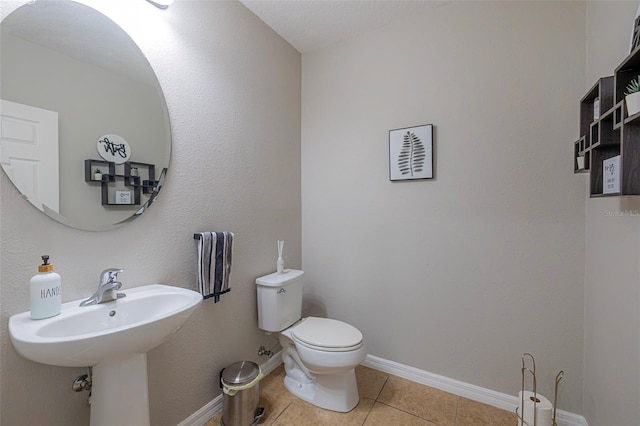 565 Ogelthorpe Dr, Davenport, FL 33897 - bathroom with toilet and tile patterned floors