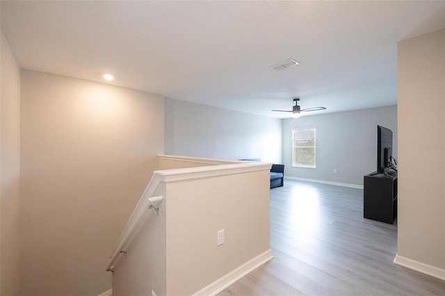 565 Ogelthorpe Dr, Davenport, FL 33897 - corridor with an upstairs landing, light wood-style floors, and recessed lighting