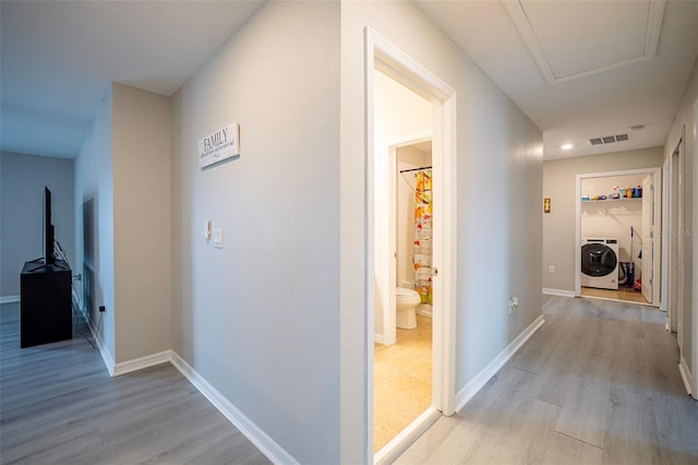 565 Ogelthorpe Dr, Davenport, FL 33897 - hall featuring light wood finished floors and separate washer and dryer