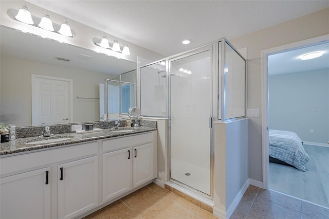 565 Ogelthorpe Dr, Davenport, FL 33897 - full bath featuring double vanity, a stall shower, ensuite bathroom, and tile patterned flooring