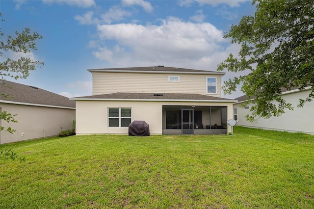 565 Ogelthorpe Dr, Davenport, FL 33897 - back of property with a lawn, a sunroom, and a shingled roof