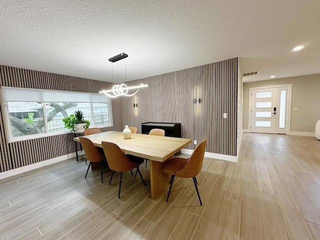 213 W Tilden St, Winter Garden, FL 34787 - dining room featuring a chandelier, light wood-style flooring, a textured ceiling, and recessed lighting