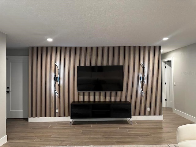 213 W Tilden St, Winter Garden, FL 34787 - living area with wood finished floors, an accent wall, and recessed lighting