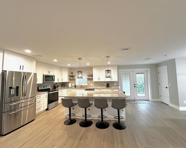 213 W Tilden St, Winter Garden, FL 34787 - kitchen with appliances with stainless steel finishes, open shelves, decorative backsplash, white cabinetry, and recessed lighting