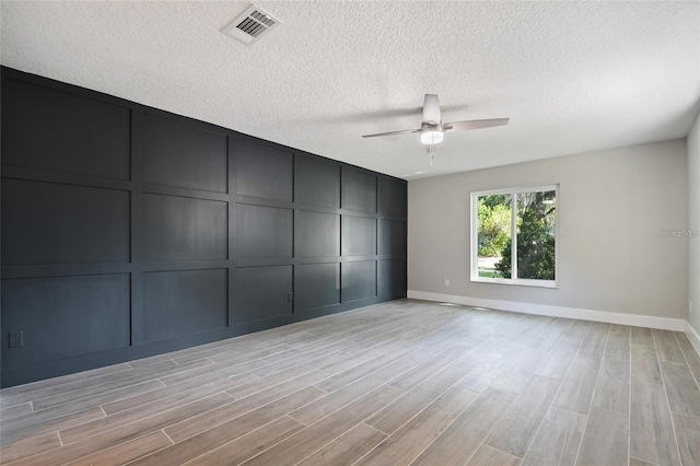 213 W Tilden St, Winter Garden, FL 34787 - unfurnished room featuring a decorative wall, ceiling fan, light wood-type flooring, and a textured ceiling