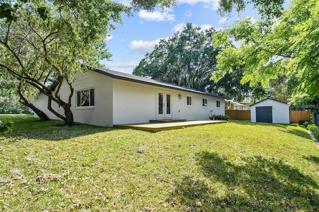 213 W Tilden St, Winter Garden, FL 34787 - rear view of house featuring french doors, a shed, a wooden deck, and concrete block siding