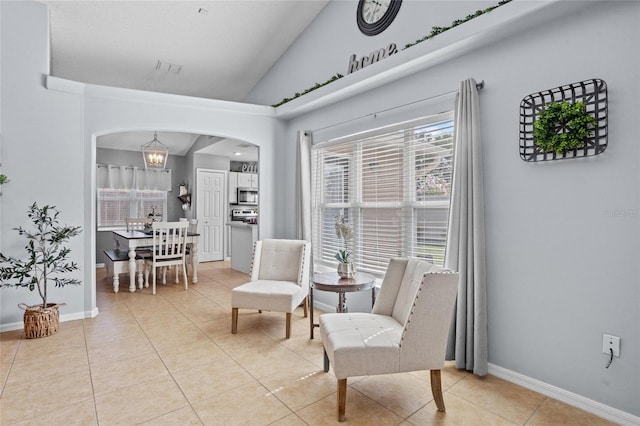 2980 Cool Breeze Cir, Saint Cloud, FL 34769 - living area featuring arched walkways, lofted ceiling, light tile patterned floors, and a chandelier