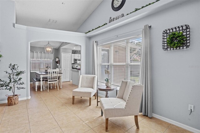 2980 Cool Breeze Cir, Saint Cloud, FL 34769 - living area featuring arched walkways, lofted ceiling, light tile patterned floors, and a chandelier