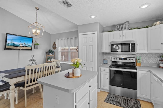 2980 Cool Breeze Cir, Saint Cloud, FL 34769 - kitchen featuring stainless steel appliances, light countertops, a chandelier, backsplash, and lofted ceiling