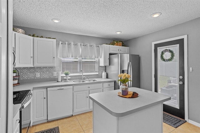 2980 Cool Breeze Cir, Saint Cloud, FL 34769 - kitchen with appliances with stainless steel finishes, plenty of natural light, light countertops, white cabinetry, and a textured ceiling