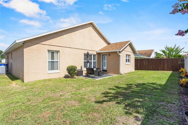 2980 Cool Breeze Cir, Saint Cloud, FL 34769 - rear view of house with stucco siding, a fenced backyard, and a patio area