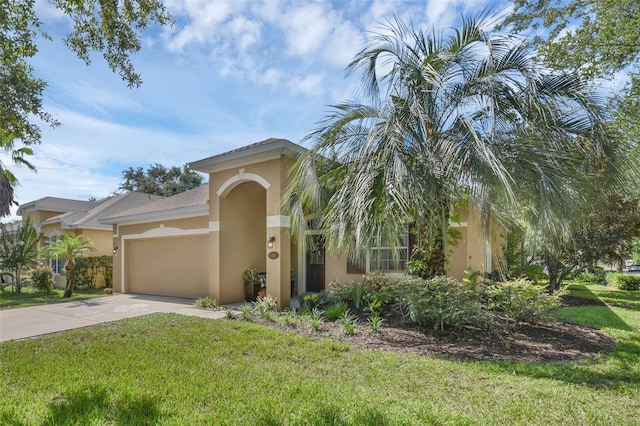 215 Foxglove Way, Deland, FL 32724 - mediterranean / spanish-style home featuring an attached garage, stucco siding, a front yard, and concrete driveway